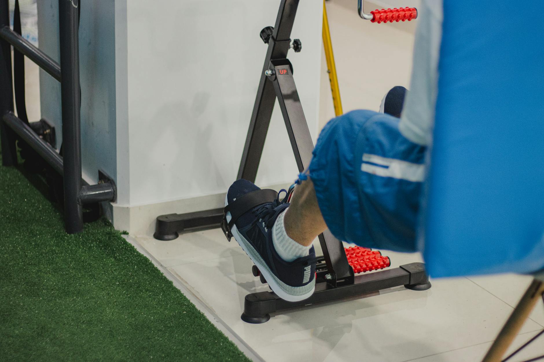 Man training at high intensity on a stationary bike during an indoor cycling workout session