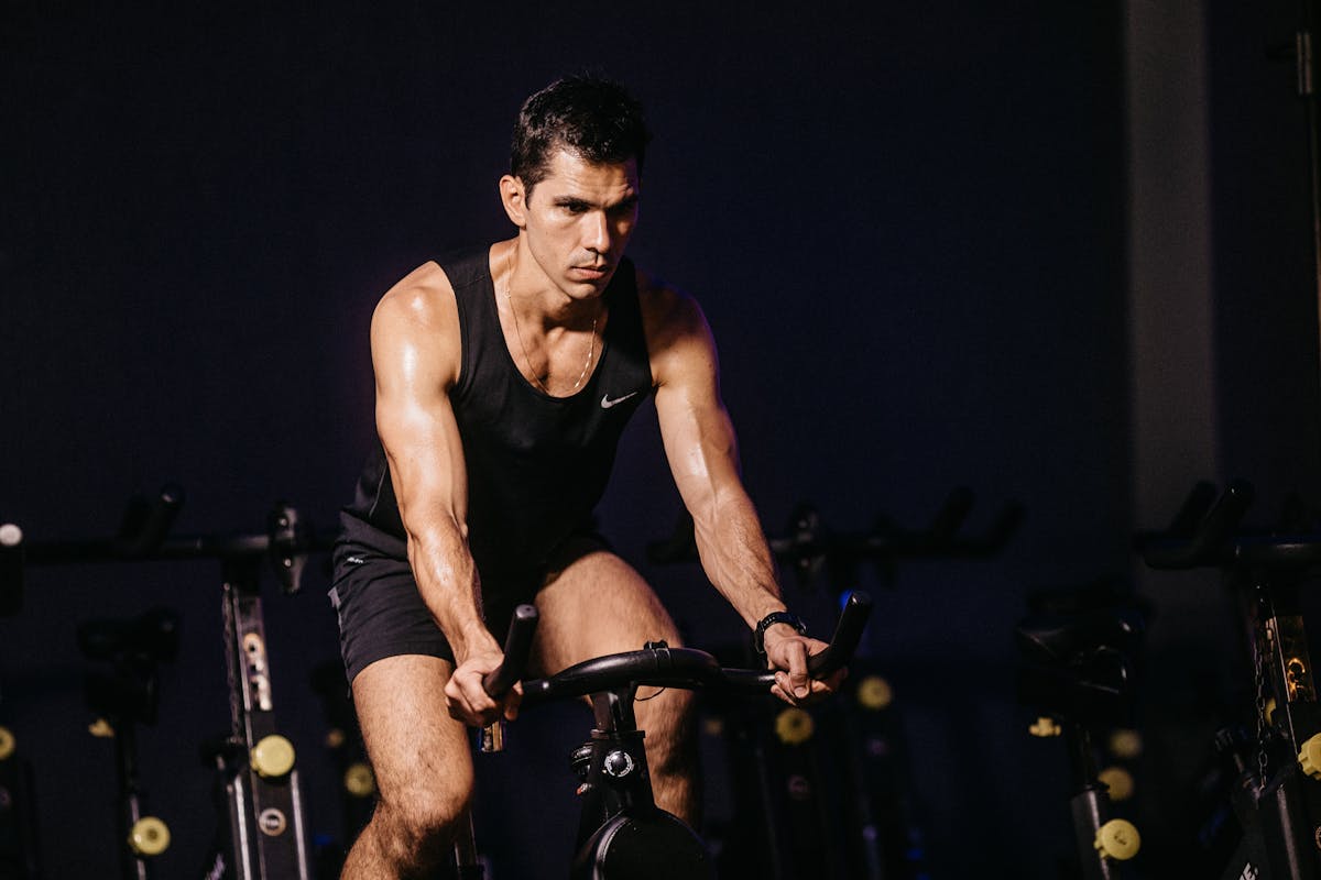 Man training on indoor cycling bike with focus and intensity, representing AI-driven cycling training