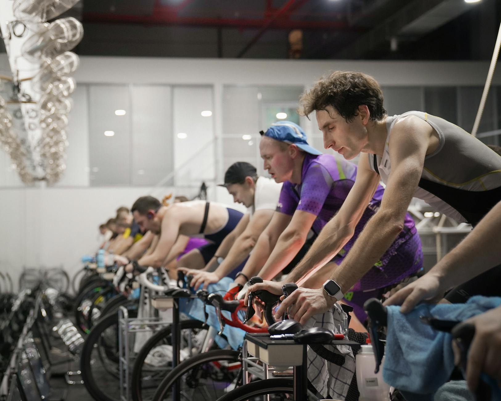 Athletes in a high-intensity indoor cycling session on smart trainers, demonstrating the best indoor cycling apps in action