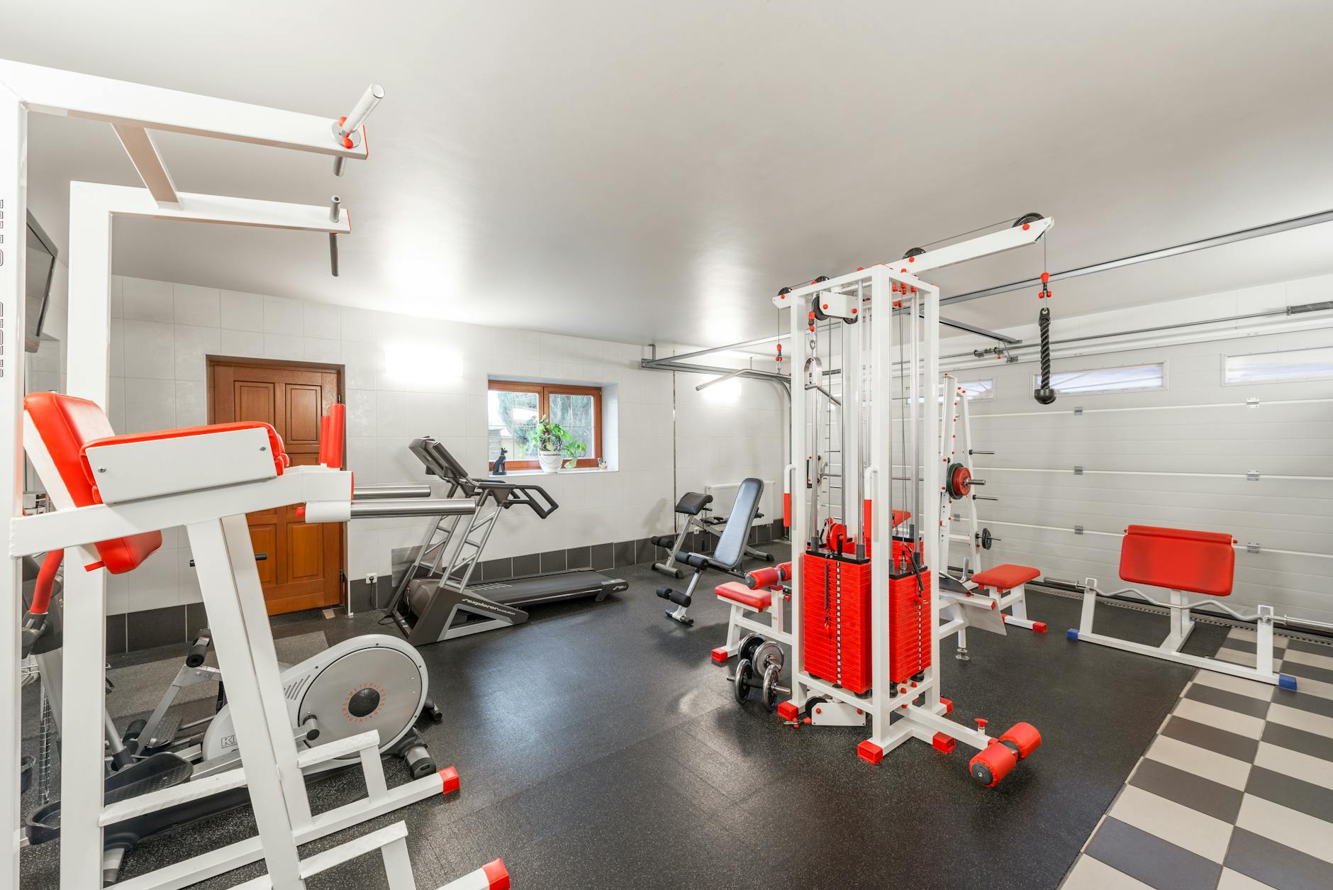 Home gym with exercise bike and fitness equipment in a compact basement space